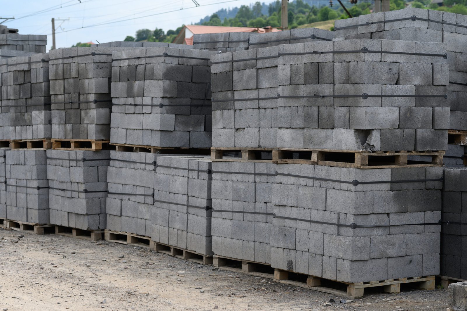 White brick for construction. Cinder blocks stacked on pallets were purchased for the construction of a house in the countryside.